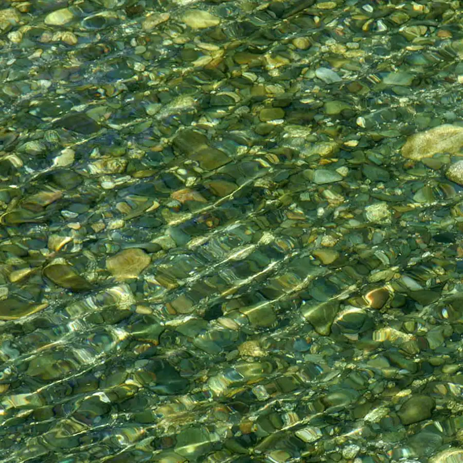 Aguas cristalinas y rocas, reflejo de luz en la Serra da Estrela.