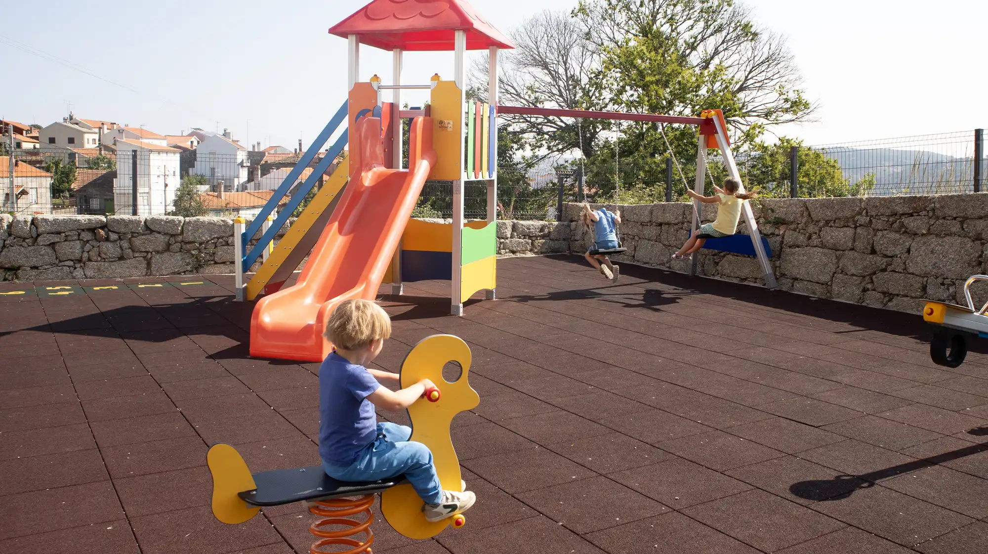 Children playing on a playground surrounded by mountains at Starbase18.